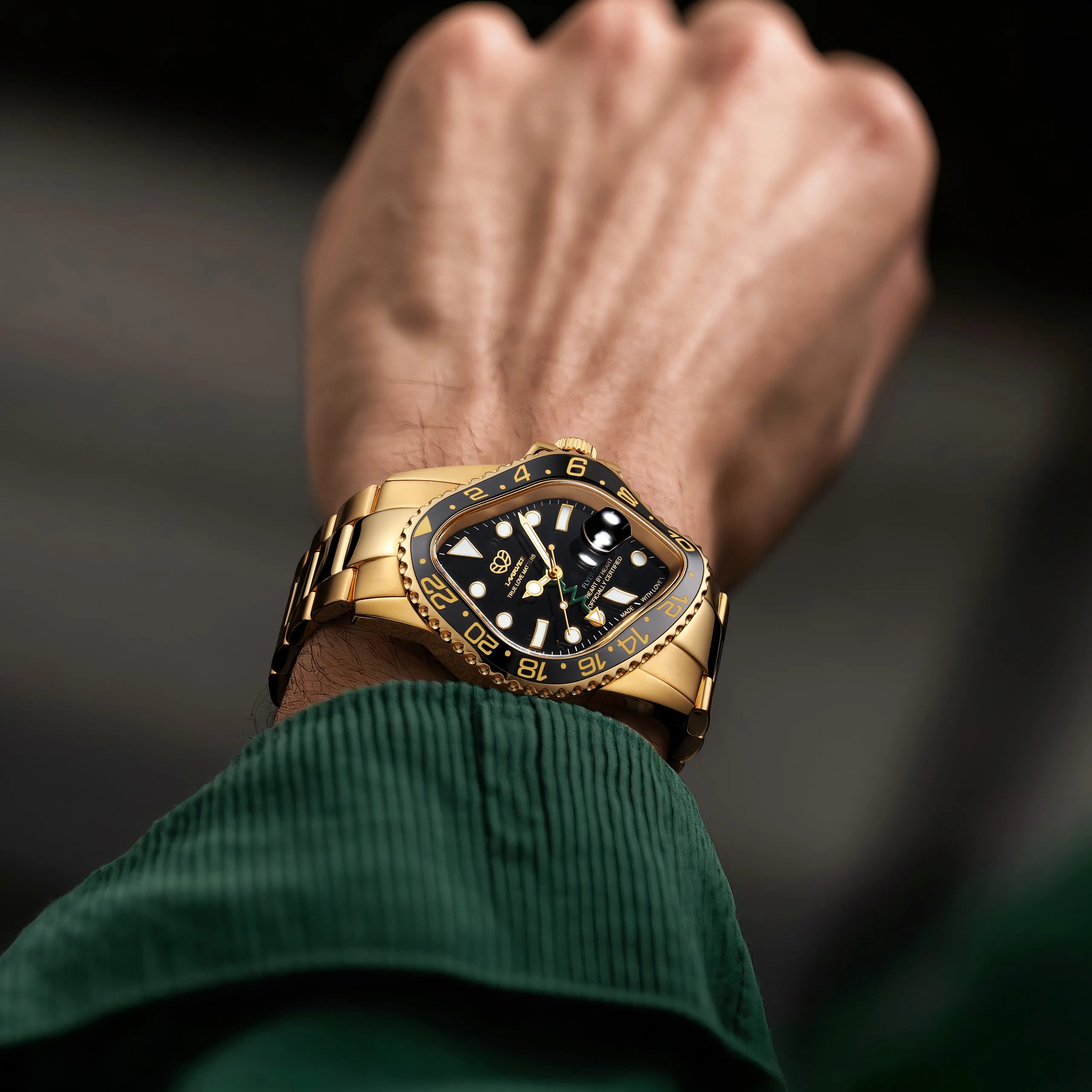 Model wearing the Laarvee PEA001GMT-GBLK gold GMT watch with black dial and green GMT hand on the wrist.